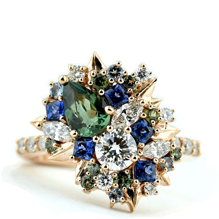 The Dana cluster engagement ring with blue and green gemstones by Abby Sparks Jewelry.
